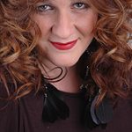 Woman in black shirt and brown curly hair