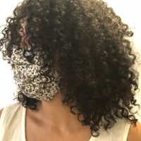 Woman wearing long black curly hairstyle styled by Leslie Ellen Curly Hair Salon NYC