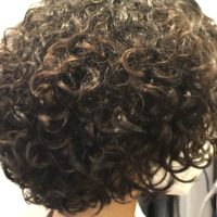 Short black tight curly hairstyle from Leslie Ellen Curly Hair Salon NYC