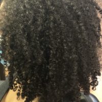 Woman wearing long black natural curly hairstyle from Leslie Ellen Curly Hair Salon NYC