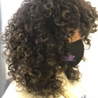 Women's black long curly hair with big curls by Leslie Ellen Curly Hair Salon NYC