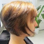 A person with short, light brown hair styled in a modern bob haircut