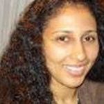 Woman with long tight black curls before makeover