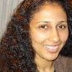 Woman with long tight black curls before makeover