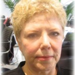 A woman with short blond hair in salon before makeover