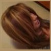 Woman with dark brown and chunky blonde highlights in straight hair