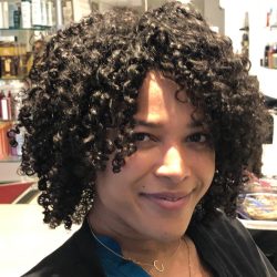 Woman with short black tight curls